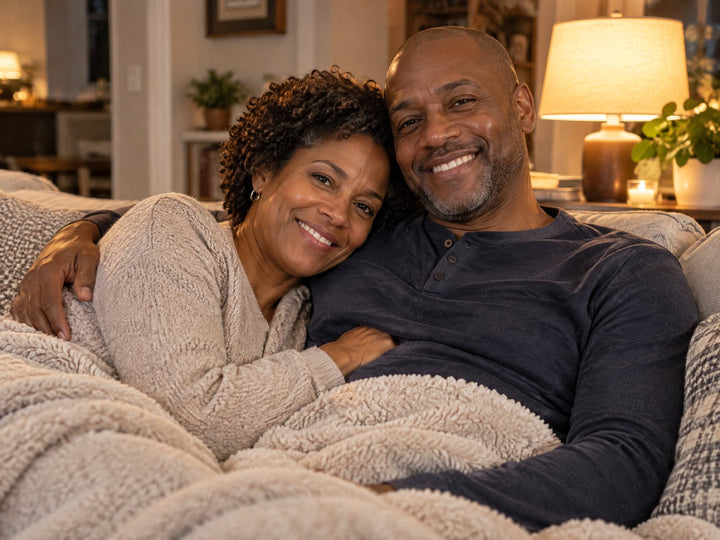 A couple cuddled on the sofa