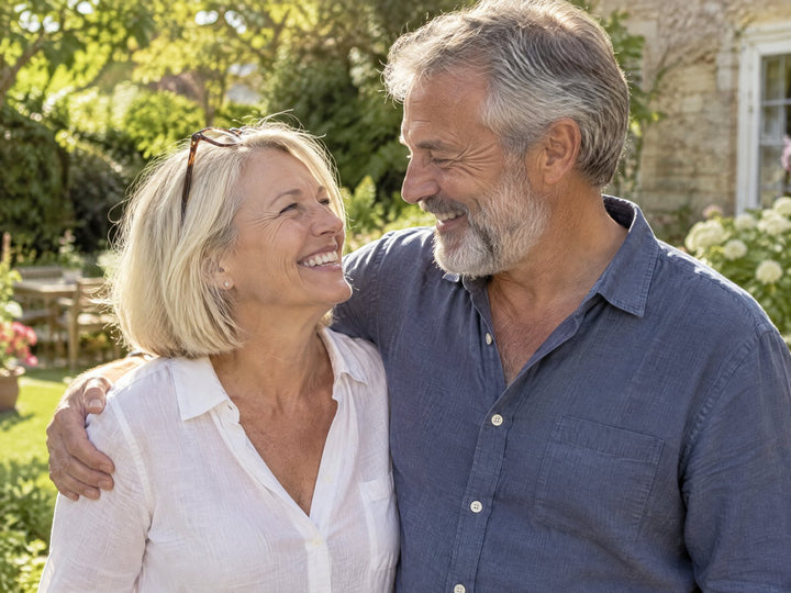 A couple laughing together in their garden